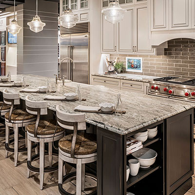 kitchen with black and white cabinets with granite countertops