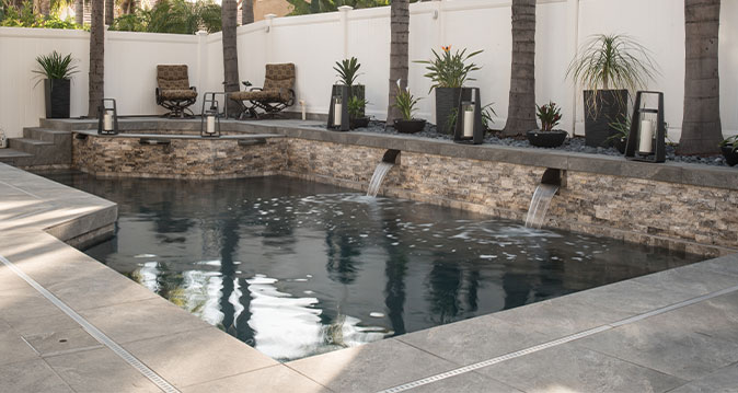 Outdoor pond with pavers, coping, and stacked stone