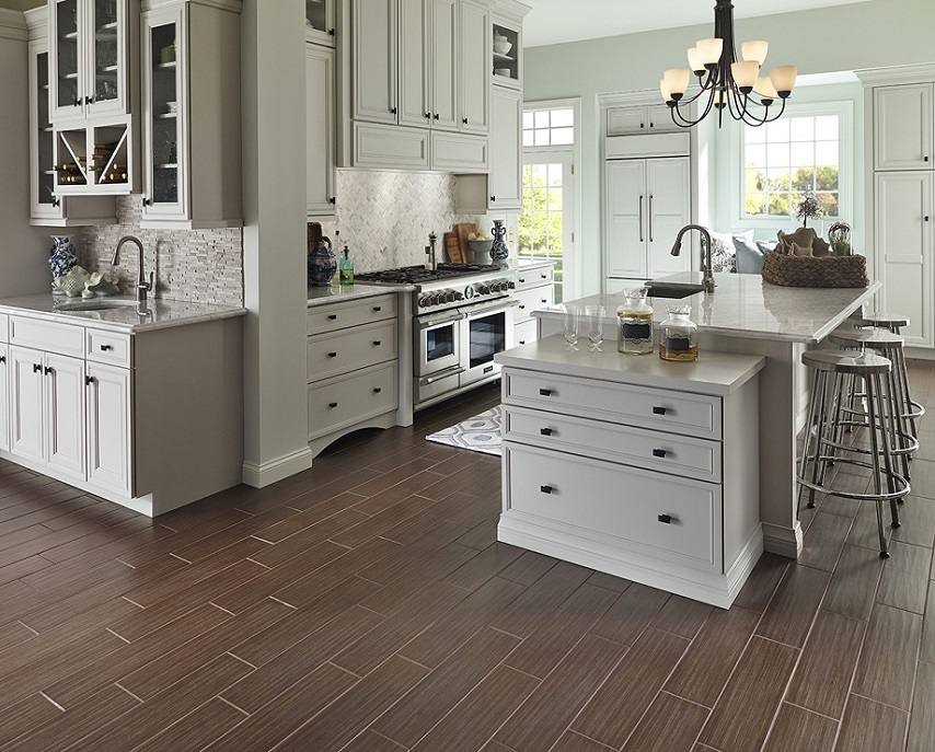 Modern white kitchen with hardwood flooring and marble countertops